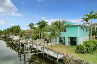 YES, THE GARAGES ALL CLOSE UP. AND OPENS ALL ROUND ON THE END ON THE RIGHT.4 OF THEM AND A WORKSHOP. DOCK AND 1 LIFT FOR THE JET SKIS 2 OF THEM AND ONE FOR THE BOAT A LIFT. FISH ON THE DOCK. TIKI BAR, TV OUT DOOR SHOWER BBQ AND MORE. WATER AND ELEC ON DOCK. THE HOME SITES UP HIGH. THE WHOLE BOTTOM IS GARGES AND THEY ARE AMAXING. ON HAS A TOLIET AND OUTSIDE SHOWER. FLAT SCREEN TV. TIKI BAR. | Image 2