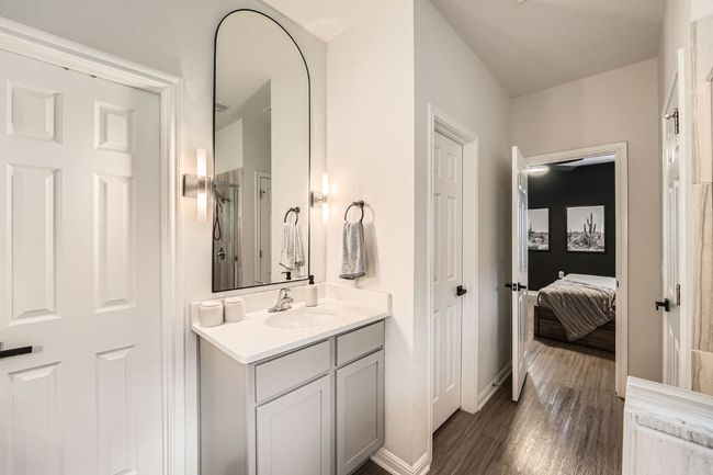Bathroom with baseboards, vanity, and wood finished floors | Image 18