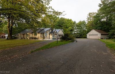 View of front of property with a garage, a front lawn, and an outbuilding | Image 2