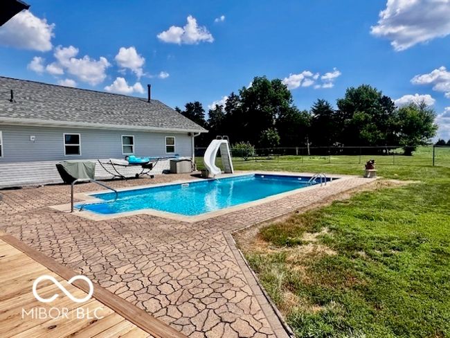 view of swimming pool featuring a water slide and a patio | Image 68