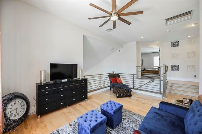 Living area with visible vents, baseboards, wood finished floors, and ceiling fan | Image 39