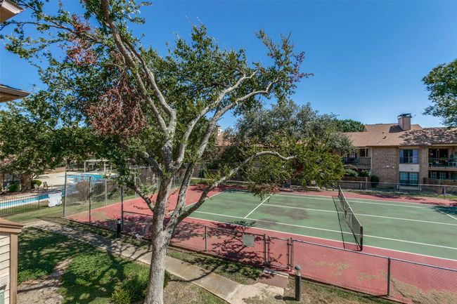 View of tennis court with fence | Image 11