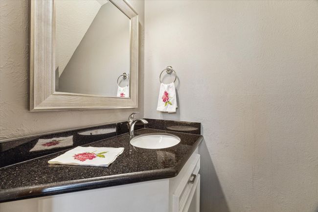 The powder room is located off the entryway. | Image 17