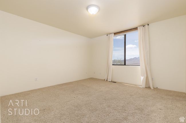 Carpeted spare room featuring a mountain view | Image 38