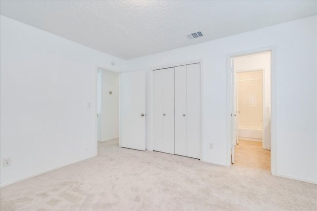 Unfurnished bedroom with carpet flooring, a closet, baseboards, and a textured ceiling | Image 26