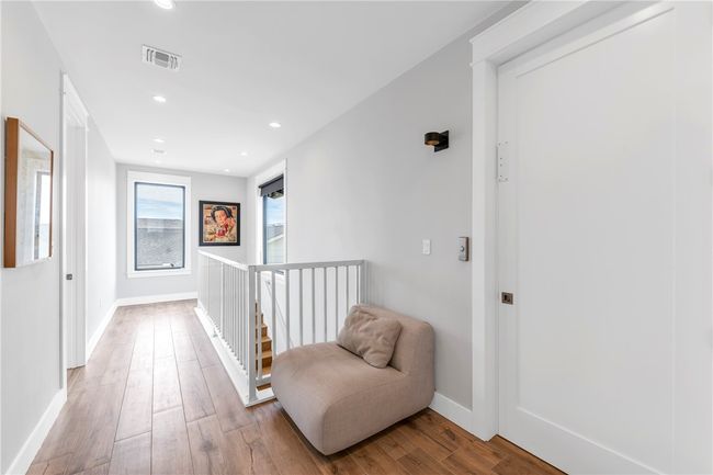 Upstairs landing and hallway showing elevator door in foreground. | Image 24