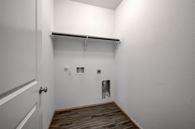 Laundry room featuring hookup for a gas dryer, washer hookup, dark wood finished floors, hookup for an electric dryer, and baseboards | Image 12