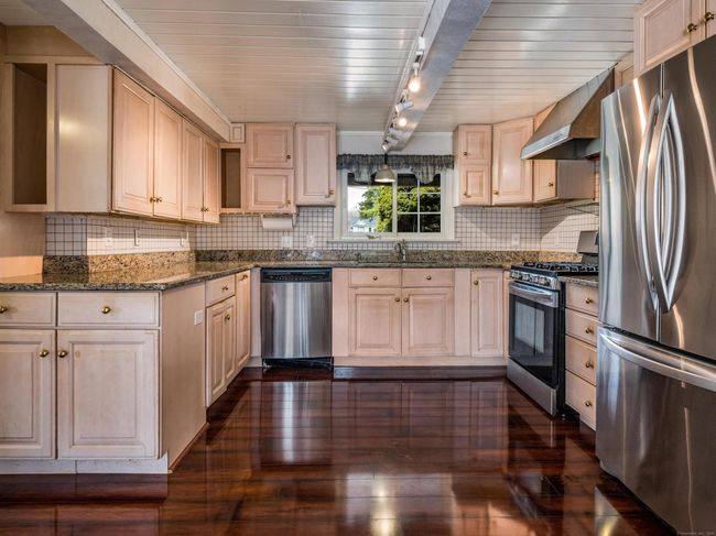 Plenty of cabinet space, stainless steel appliances, gas range, and granite countertops. | Image 12