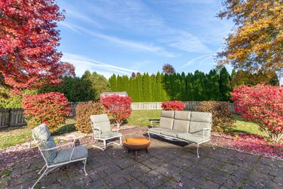 Spacious backyard with brick patio and firepit area | Image 3