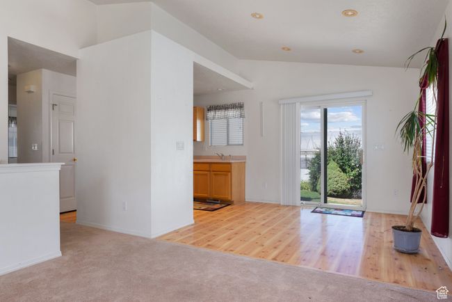Carpeted entrance foyer with vaulted ceiling and baseboards | Image 7