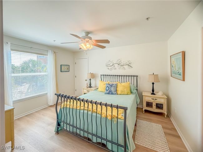 Bedroom featuring light wood finished floors, ceiling fan, and baseboards | Image 38