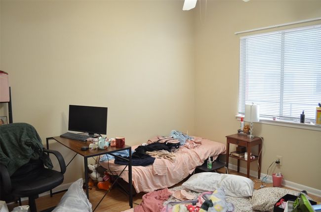 Bedroom featuring wood finished floors and a desk | Image 10