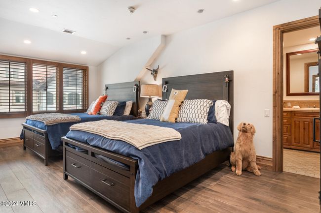 With ample space and stylish comfort, the guest suite offers two beds, ensuite access, and charming mountain views—ideal for family or friends. | Image 17