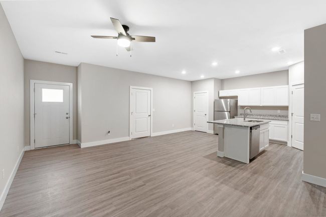 Kitchen featuring a sink, an island with sink, recessed lighting, baseboards, and stainless steel appliances | Image 8