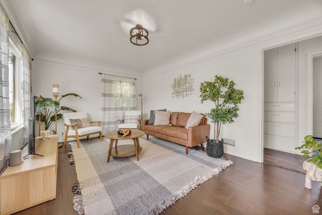 Living room featuring wood finished floors and baseboards | Image 4