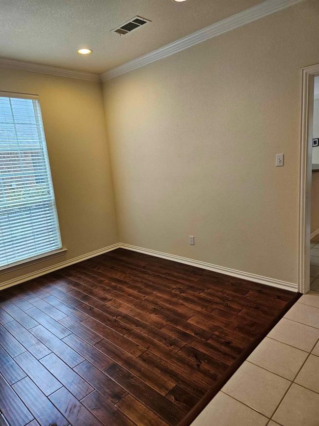 Unfurnished room featuring wood-type flooring, crown molding, plenty of natural light, recessed lighting, and a textured ceiling | Image 15