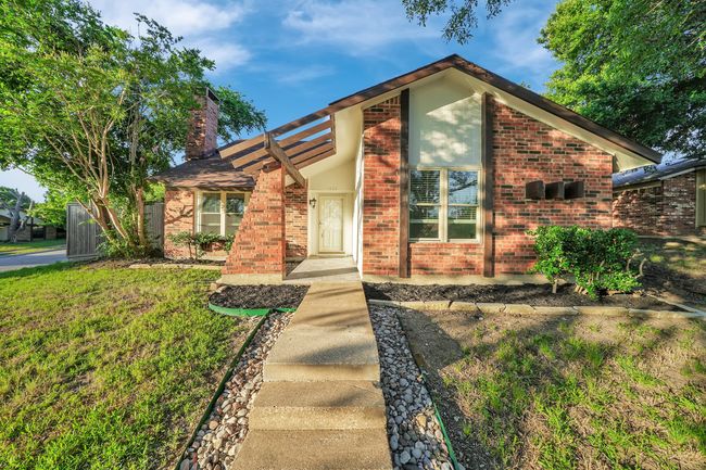 View of front of house with a chimney and brick siding | Image 4