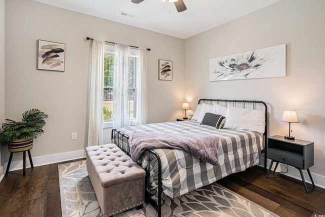 Bedroom with wood finished floors and a ceiling fan | Image 17
