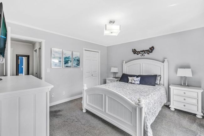 Carpeted bedroom featuring a closet, baseboards, and crown molding | Image 20