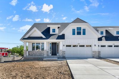 View of front facade featuring a porch and a garage | Image 1