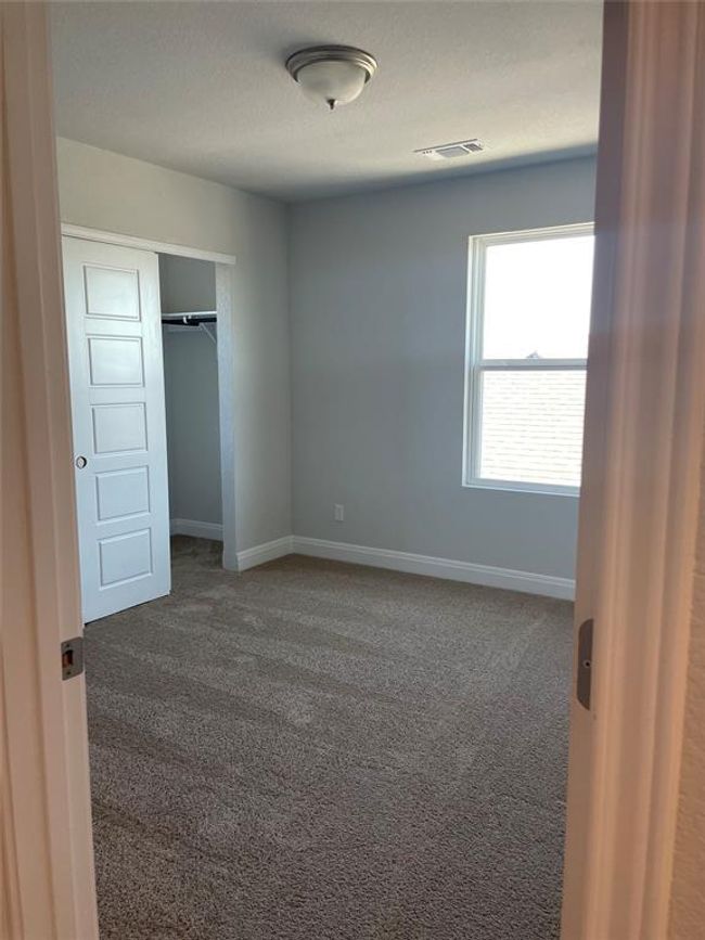 Unfurnished bedroom with carpet floors and a closet | Image 19