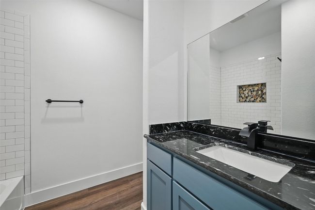 Bathroom with wood finished floors, vanity, and baseboards | Image 11