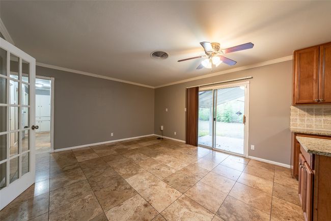 Unfurnished dining area featuring a ceiling fan and crown molding | Image 12