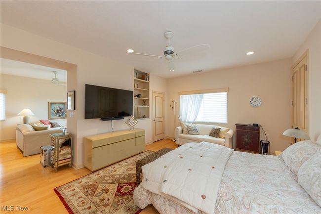 Primary Bedroom with wood finished floors, ceiling fan, recessed lighting, and visible vents | Image 28