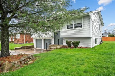 Split foyer home featuring a front lawn and a garage | Image 2