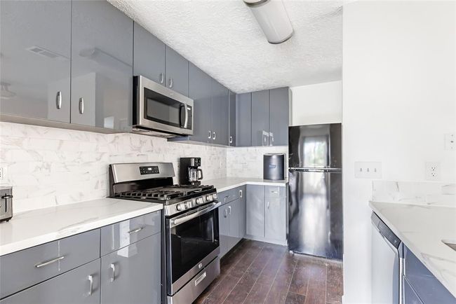 Nice wood floors flow from living room to kitchen and dining area. | Image 8