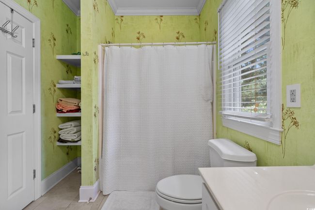 Bathroom with tile patterned flooring, vanity, ornamental molding, and curtained shower | Image 35