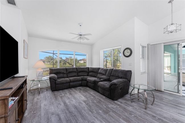 Family room has a vaulted ceiling and ceiling fan. | Image 15