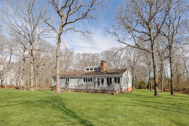 Rear view of house with a lawn and a chimney | Image 35