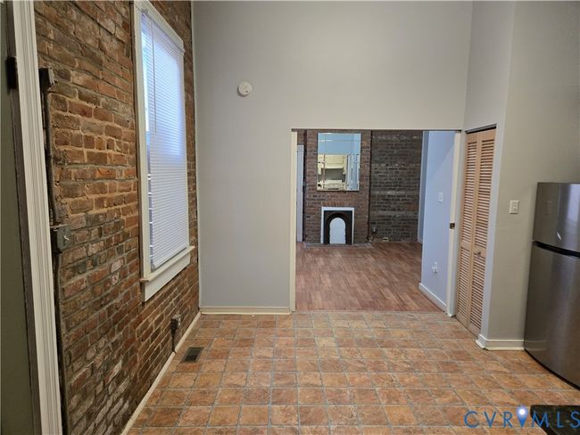 Hall with brick wall and a high ceiling | Image 7