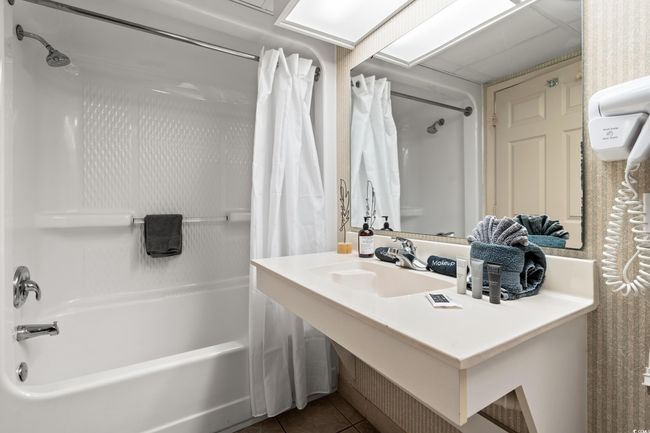 Bathroom with shower / tub combo and tile patterned floors | Image 10