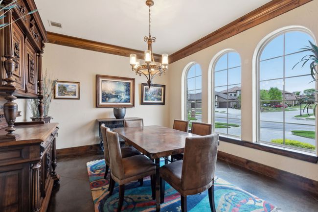 Dining area featuring baseboards, visible vents, a notable chandelier, and plenty of natural light | Image 16