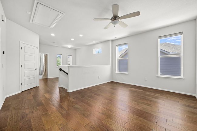 Unfurnished room with recessed lighting, a ceiling fan, attic access, and dark wood-style floors | Image 17