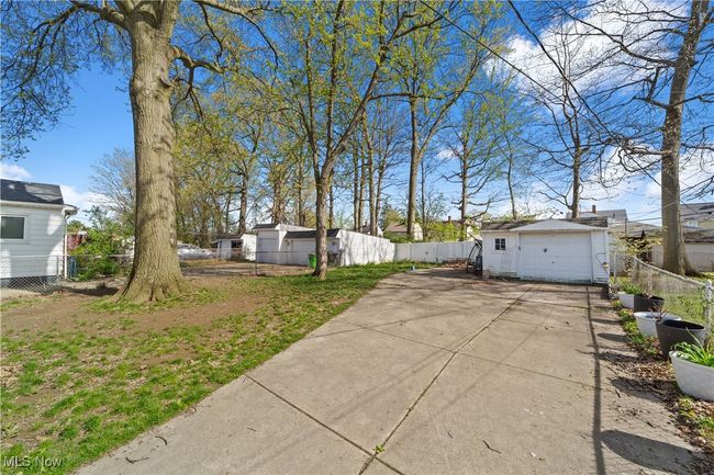 View of yard with driveway, an outdoor structure, and a garage | Image 11