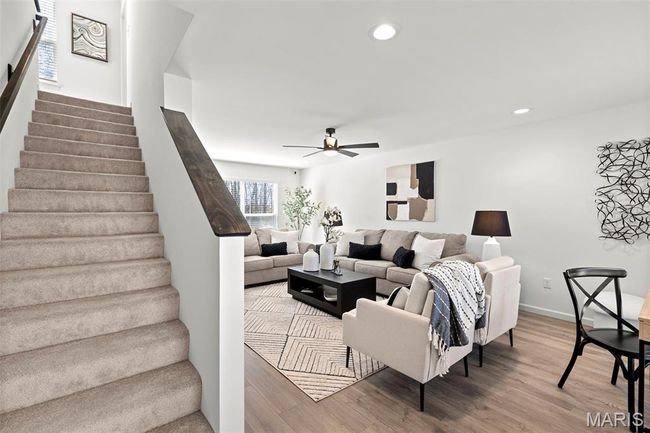 Living room featuring ceiling fan, wood finished floors, stairway, recessed lighting, and baseboards | Image 4
