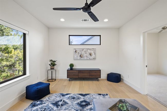 Bedroom featuring visible vents, baseboards, and wood finished floors | Image 25