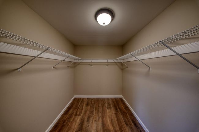 Spacious closet with wood finished floors | Image 19