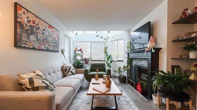 Living room featuring a fireplace and wood finished floors | Image 8