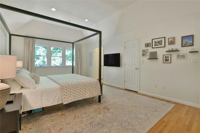 The primary suite, nestled at the rear of the house facing the backyard and total privacy, has a hallway with two large closets in addition to the big walk in closet seen here. | Image 17
