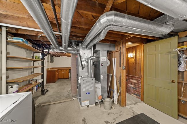 Unfinished below grade area featuring heating unit and refrigerator | Image 9