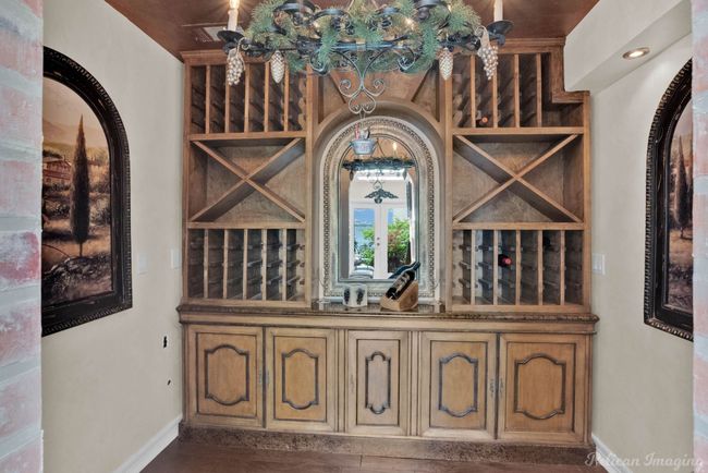Wine room with baseboards and arched walkways | Image 15