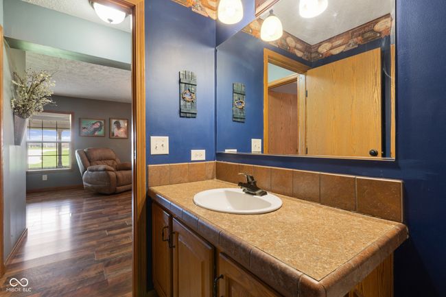 bathroom with vanity, wood finished floors, and a textured ceiling | Image 28