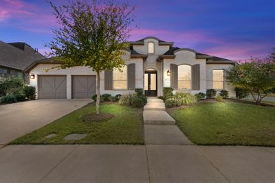 French country inspired facade with a yard and a garage | Image 1