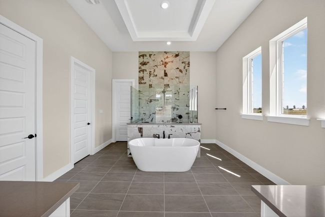Full bath with a marble finish shower, tile patterned flooring, a soaking tub, a raised ceiling, and recessed lighting | Image 13