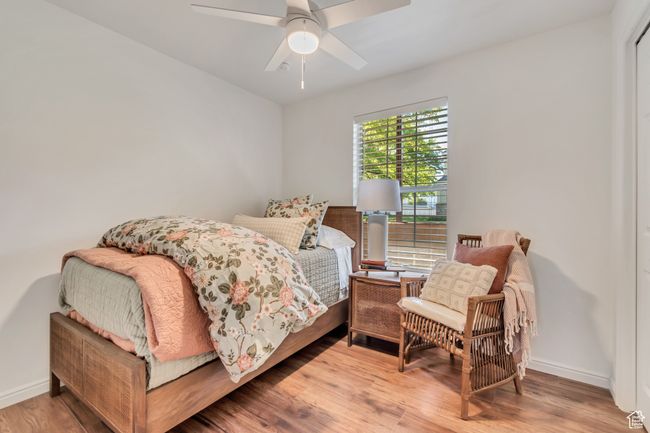 Bedroom with wood finished floors, baseboards, and ceiling fan | Image 8
