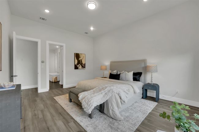 Bedroom with baseboards, wood finished floors, and visible vents | Image 26